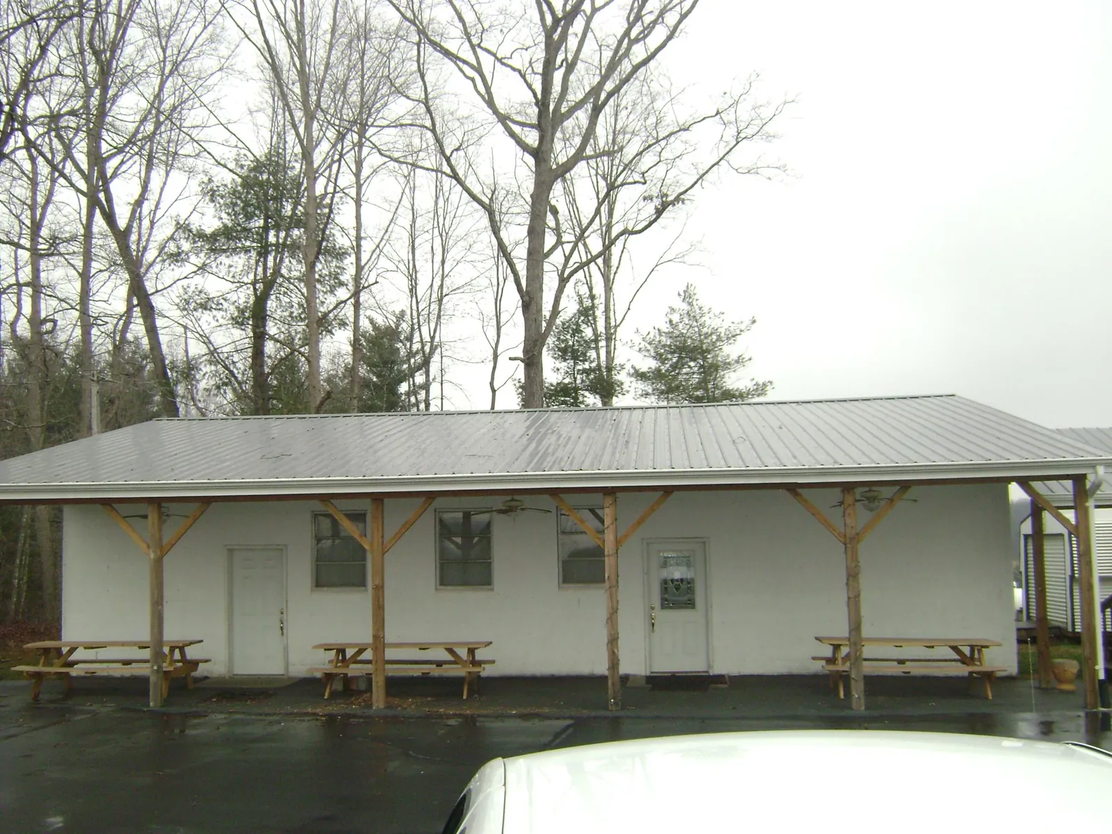 Gray metal roof over a block building with a timber post porch in Weatherly